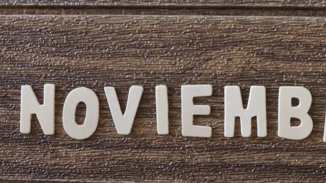 Text made of wooden letters spelling out the month of November.