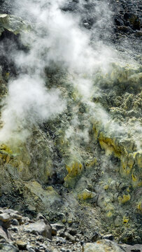 A volcano crater with an acid lake (explosion lake) and steaming fumaroles and hot springs. Sulawesi. Indonesia