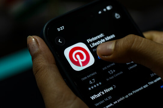In this photo illustration, a person holds a smartphone displaying the Pinterest app on the App Store, in New Delhi, India on 8 August 2026.