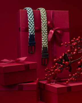 Stylish belts displayed with red gift boxes