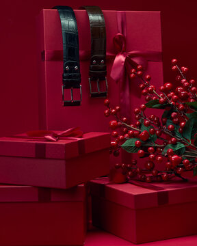 Gift boxes and red decorations on a red background