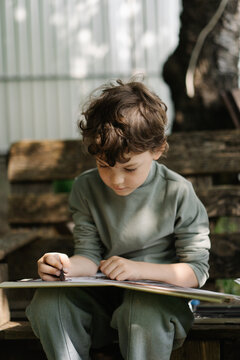 Little artist creating colorful outdoor childhood moments