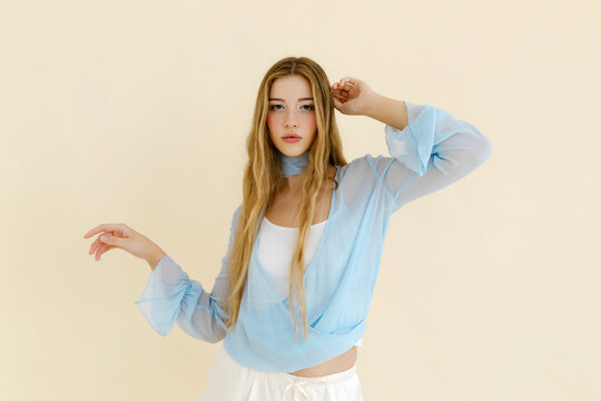 Young woman posing in stylish blue blouse