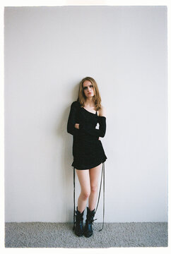 Fashion Model stands in a simple pose wearing black clothing