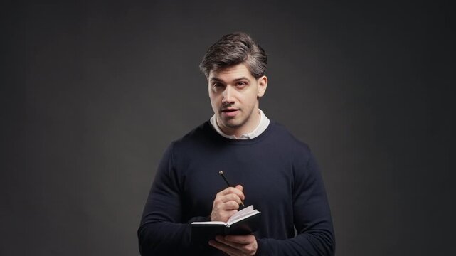 Young Adult Businessman Writing Future Plans In Planner, Professional Man Taking Notes In Notebook, Creating A To Do List And Organizing Weekly Tasks, Office And Student Lifestyle