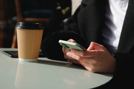 Woman using smartphone at table