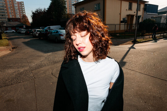 Woman with closed eyes outdoors