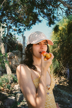 Enjoying Fresh Fruit Outdoors Near Trees Portrait