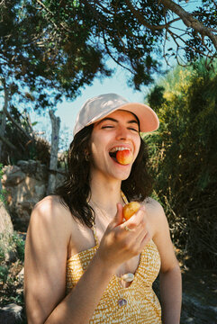 Happy Woman Enjoying Fruit Outdoors 