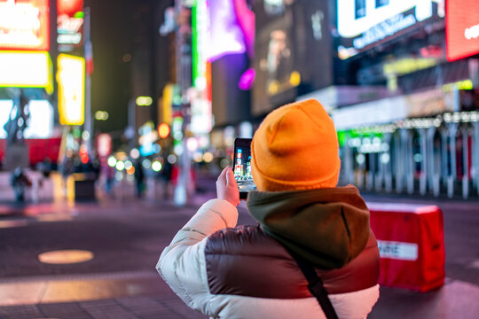 Tourist taking photo Times Square colorful, New York

