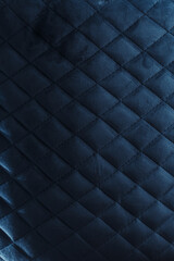 Obraz premium Moody Dark Blue Quilted Velvet Upholstery Texture with Diagonal Diamond Pattern