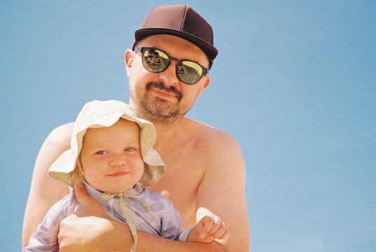 Father and baby opposite the blue sky