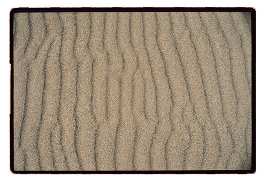 Wind-carved ripples across a flat stretch of sand