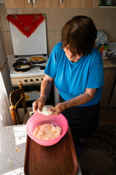 Elderly Woman Preparing Traditional Homemade Fried Dough