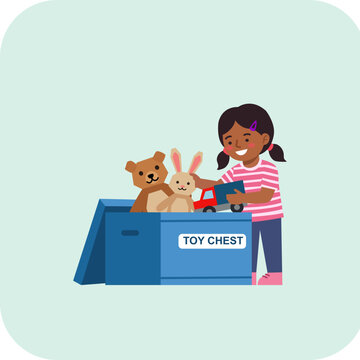 Happy little girl organizing teddy bear bunny and toy car inside a children's toy chest