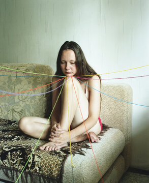 Person Surrounded by colorful Threads