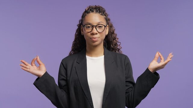 Calm african american teen girl relaxing, meditating, refuses stress. Curly teenager breathes deeply, calms down violet studio background. Yoga, moral balance, zen concept.