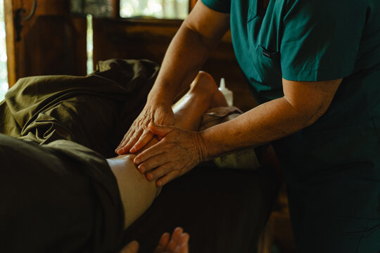 Professional hands giving therapeutic leg massage for relaxation