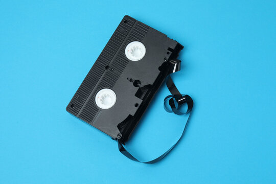 A video cassette against a colored background. An old analog VHS cassette, close-up. Retro and vintage.
