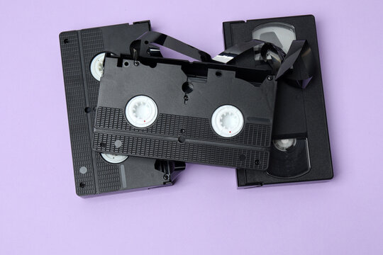 A video cassette against a colored background. An old analog VHS cassette, close-up. Retro and vintage.
