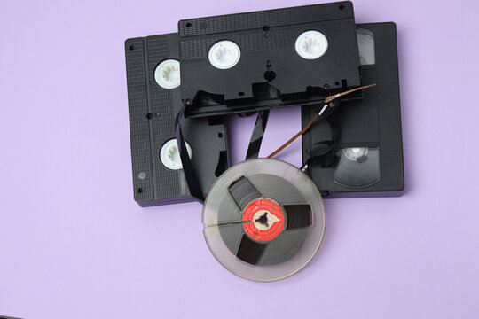 A video cassette against a colored background. An old analog VHS cassette, close-up. Retro and vintage.
