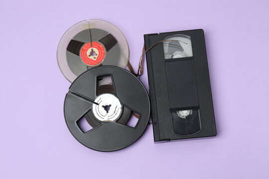 A video cassette against a colored background. An old analog VHS cassette, close-up. Retro and vintage.

