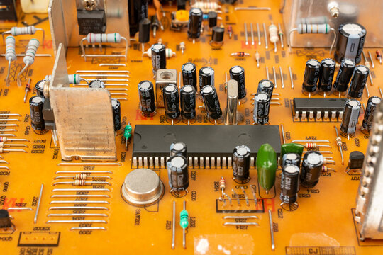 Brown printed circuit board components and parts. electronic circuit board containing radio components from an electronic device.