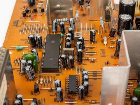 Brown printed circuit board components and parts. A circuit board with radio components from an electronic device.