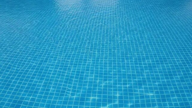 Clear blue swimming pool water with tiled bottom