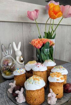 Easter celebration with decorated pastries and flowers on a table inside a home