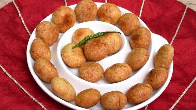 serving homemade kachori in a ceramic white plate 