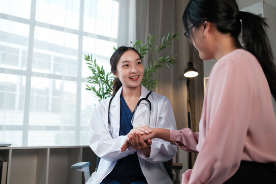 Doctor comforting patient during medical consultation in office