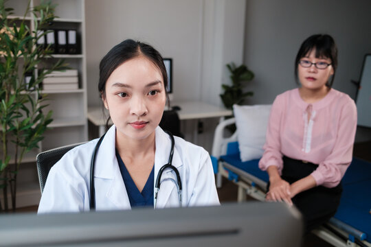 Doctor consulting patient in medical office using technology