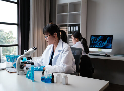 Female scientists conducting scientific research in modern laboratory