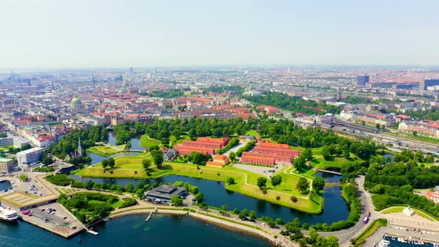 Copenhagen, Denmark. Kastellet, the star-shaped 17th-century citadel with red brick barracks and green ramparts, Drone footage over the harbor and cityscape. Drone footage, Point of interest