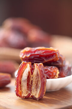 Golden Dried Dates Palm Fruit from Xinjiang on Wooden Board