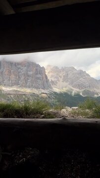 View of Sass de Stria mountain peaks through bunker window in Dolomites, Italy
