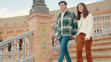 Fototapeta premium Couple Walking Up Colorful Tile Staircase