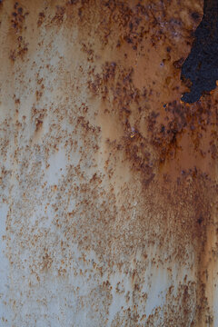 Heavy rust and corrosion on deteriorating painted metal surface