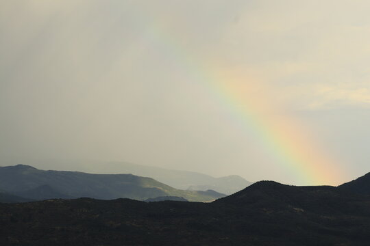 Hope and natural beauty, rainbow over Berat Castle mountains in Albania, scenic landscape after rain