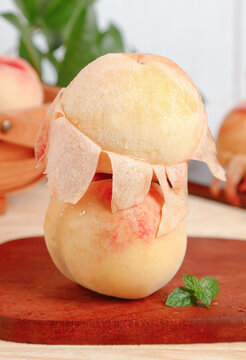 Freshly Picked Yangshan Peach Being Peeled on Wooden Board with Curled Skin Strips