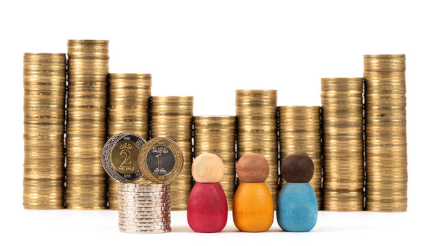 Saudi Arabian 1 and 2 riyal coins, figurines of symbolic figures, and stacks of coins on a white background.