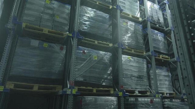 Industrial warehouse with boxes. Forklift Small cargo truck drives to warehouse. Large warehouse logistics terminal.