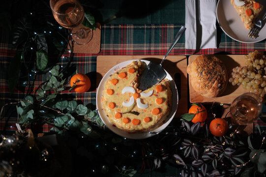 Top View Of Traditional Boeuf Salad Placed On Festive Table. Overhead shot shows homemade decorated winter appetizer platter surrounded by holiday decorations