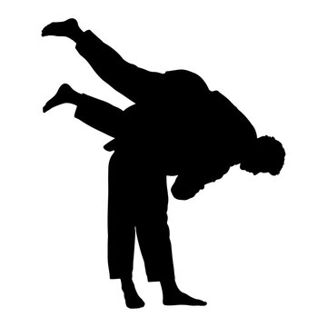 Silhouette of two martial artists practicing a judo throw