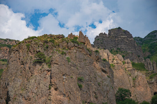 Volcanic rocks with crosses in Geghard gorge, panoramic Armenia mountain landscape with copy space
