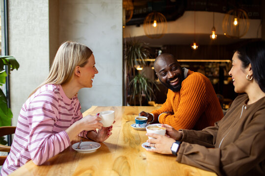 Friends meeting for coffee at cozy cafe