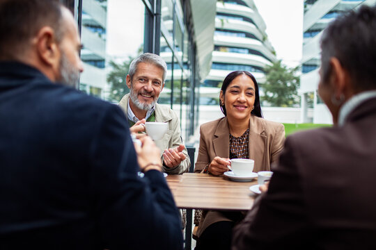 Business colleagues meeting over coffee at outdoor cafe