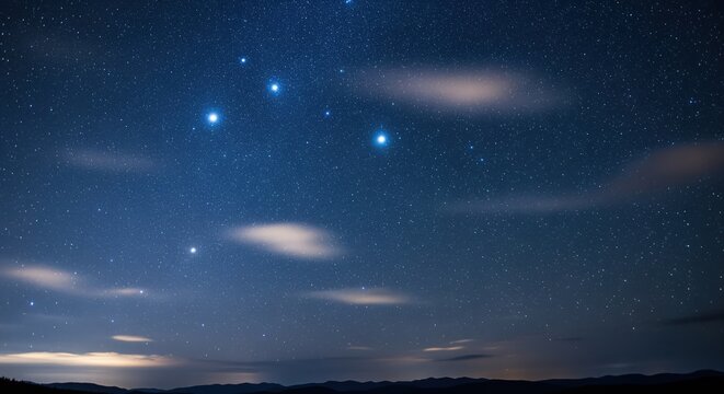A stunning night sky filled with bright stars and distant galaxies across a deep blue backdrop. Soft clouds catch the last light of dusk along the horizon. Perfect for astronomy and nature themes.