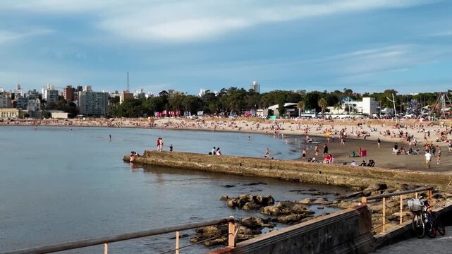 Crowded Playa Ramirez beach at sunset, Montevideo, Uruguay